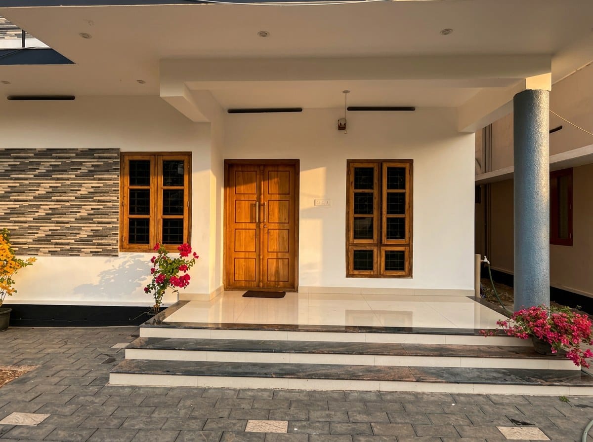 The covered entrance porch at ZENWAYS with teak double doors and bougainvillea